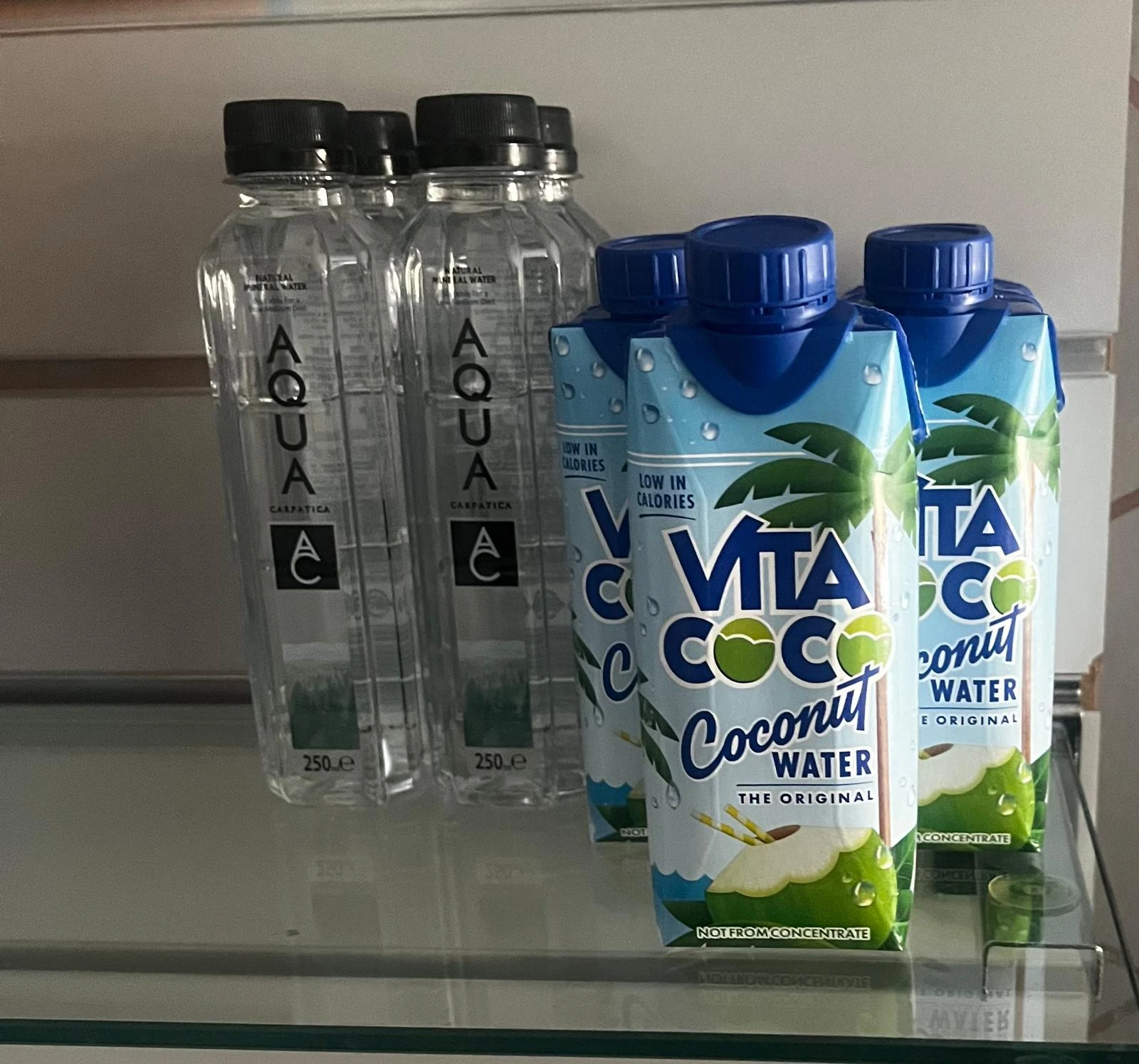 AQUA Carpatica water bottles beside Vita Coco Original Coconut Water cartons